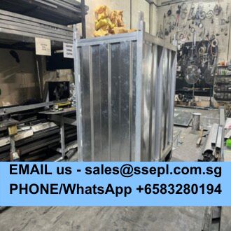 Industrial workshop scene with a large metal enclosure; a blue banner at the bottom displays contact info, including an email address and a WhatsApp number.